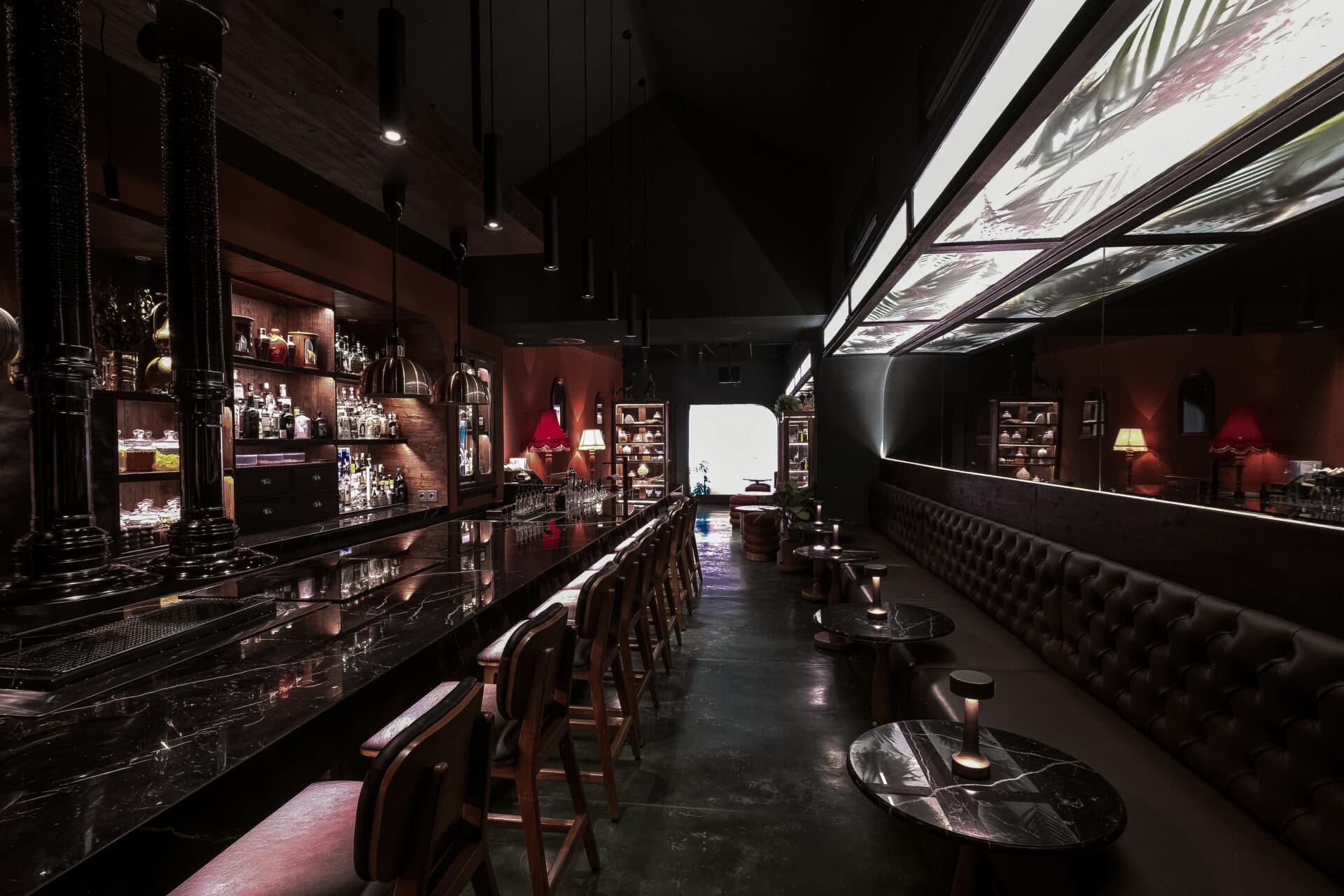 A long cocktail bar in low light