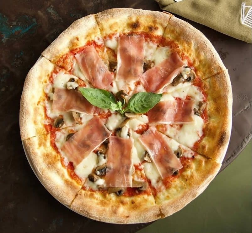 Wood-fired pizza fresh from the oven at a Canggu pizzeria