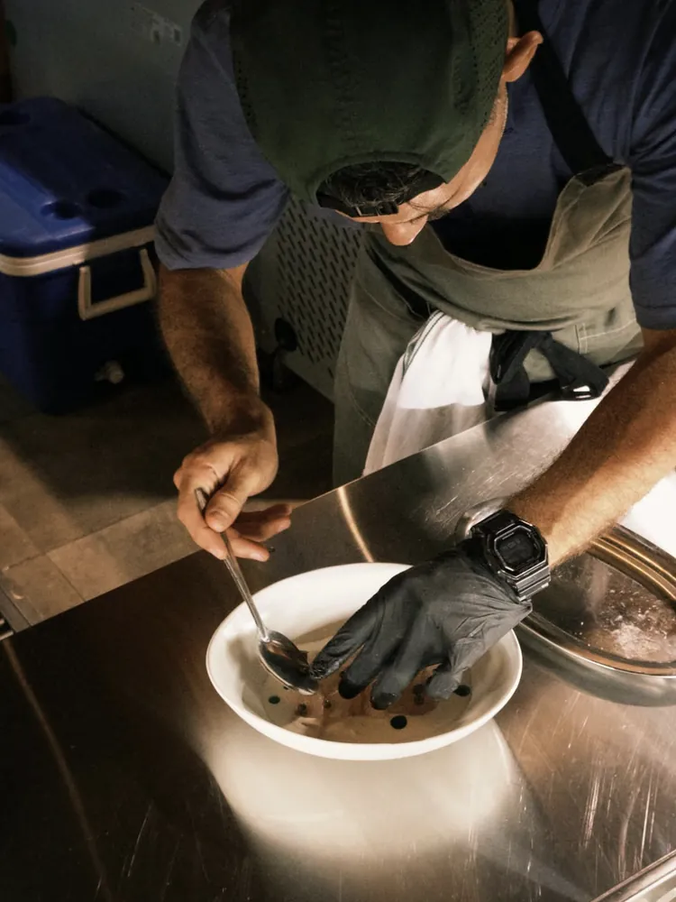 Chef plating a dish in the kitchen