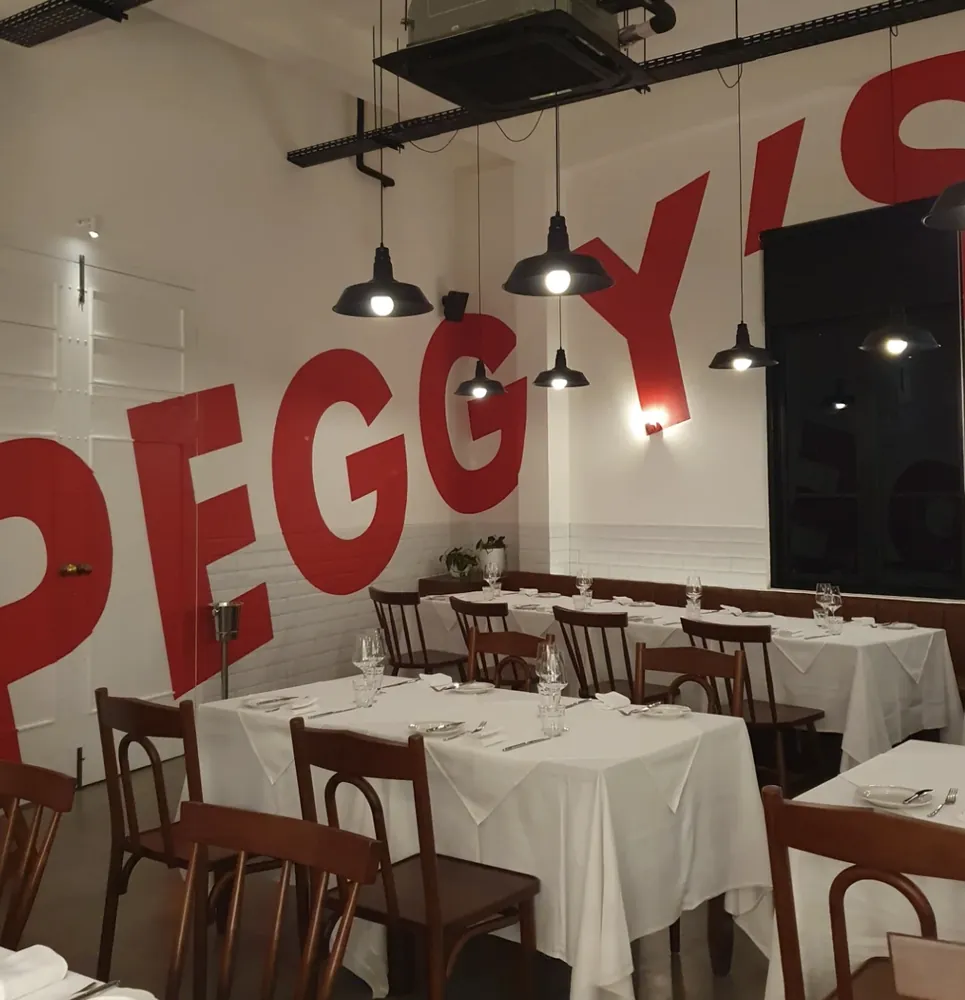 Dining room with a bold red wall mural